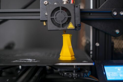 a 3d printer with a yellow cone on top of it, 3d printing service