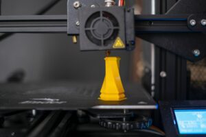 a 3d printer with a yellow cone on top of it, 3d printing service