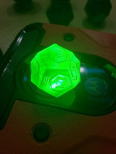 A glowing, translucent green polyhedral dice 3D printed by PlastiForge3D, showcasing unique engraving and customizable features for tabletop gaming.