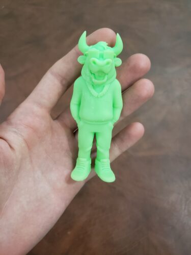 A neon green bull figurine, 3D printed by PlastiForge3D using SLA resin, showcasing intricate details and custom design features.