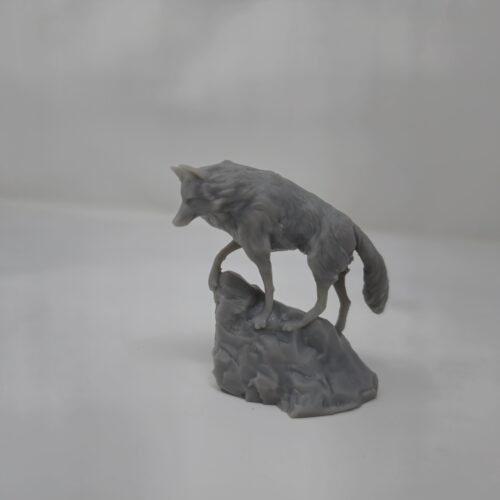 A highly detailed Snow Wolf figure in gray resin, 3D printed by PlastiForge3D and perched atop a rocky base.