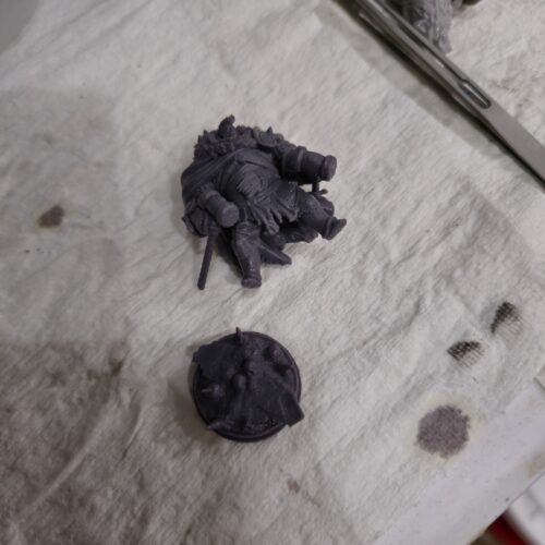 3D printed tabletop miniature of Hugo the Huge, a large fantasy warrior with sword and shield, made in high-detail resin.